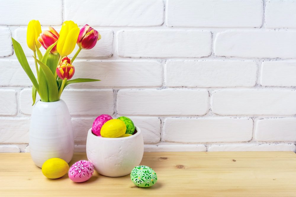 Easter rustic arrangement with eggs, red and yellow tulips