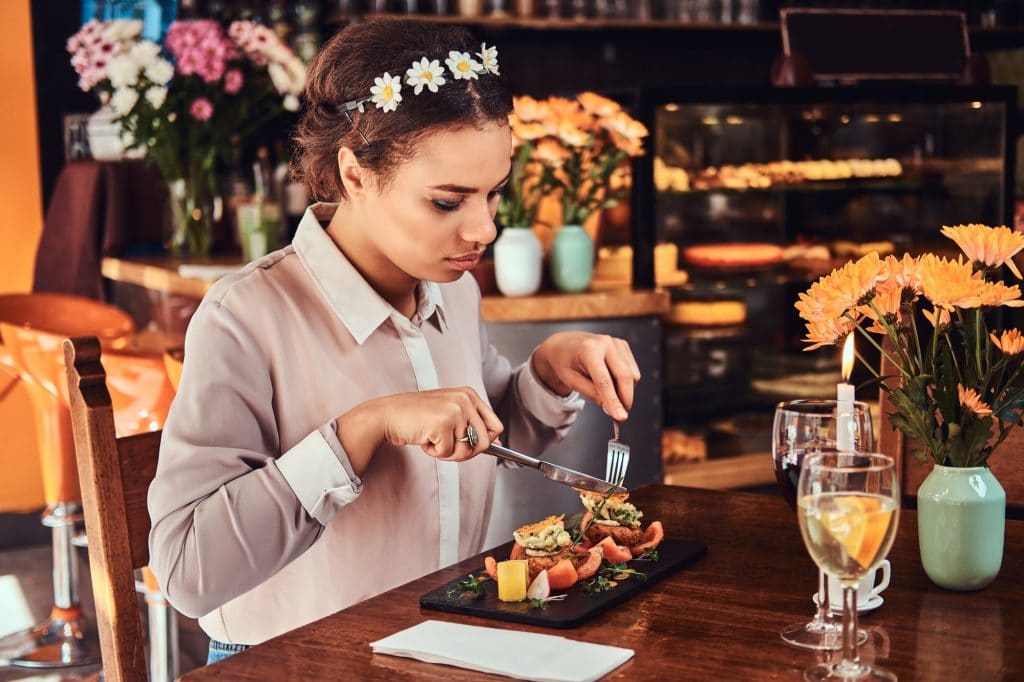 Beautiful woman wearing a blouse and flower headband in a restaurant.